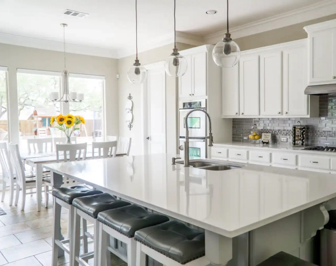 white themed kitchen with marble countertops